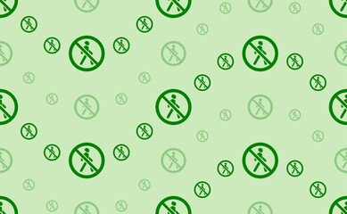 Seamless pattern of large and small green pedestrian traffic prohibited signs. The elements are arranged in a wavy. Vector illustration on light green background