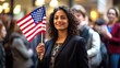 Happy smiling Female immigrant holding a small US flag the day of her naturalization ceremony