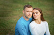 © Olga - Two happy europian people hugging and looking at camera, making photo while walking in park, expressing positive emotions. Friendship and relationship concept.