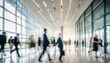 © ibreakstock - Bright office lobby with fast moving crowd of business people in long exposure shot
