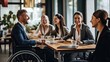 © masyastadnikova - Business meeting in a co-working space by a man in a wheelchair. Integration of people with disabilities.