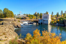 View Of Riverfront Park, With The Pavilion And Clock Tower In View Rising Above The Spokane River, The Upper Falls And Post Street Bridge In Spokane, Washington.