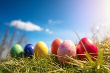 Colorful Easter Eggs On Grass Under Blue Sky. Generative AI