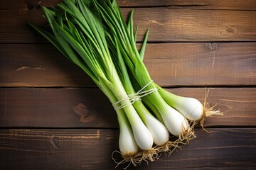 Wall Mural - Leeks placed on wooden table in flat lay arrangement