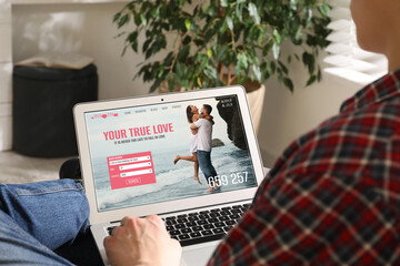 Poster - Looking for partner. Man using laptop at home, closeup. Dating site webpage on device screen