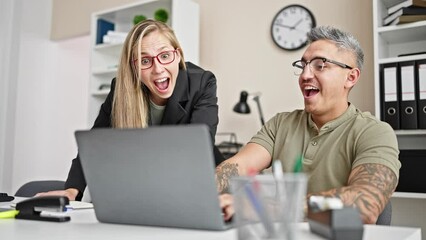 Canvas Print - Man and woman business workers high five with hands raised up working at the office