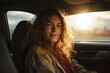 woman in car smiling in sunshine