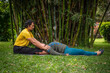 © Daniel - Thai massage therapy session, outdoors with bamboo background