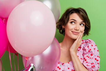 Sticker - Photo of good mood nice woman with bob hairstyle dressed pink blouse palm on cheekbone look at bubbles isolated on green color background