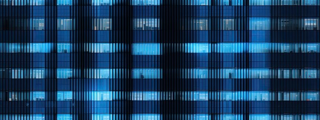 Seamless skyscraper facade with blue tinted windows and blinds at night. Modern abstract office building background texture with glowing lights against dark black exterior walls