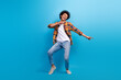 © deagreez - Full length photo of positive handsome guy dressed checkered shirt dancing having fun isolated blue color background