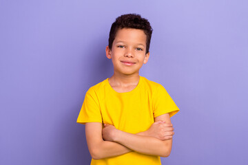 Poster - Photo of cheerful adorable boy wear yellow clothes standing with folded arms isolated on purple color background