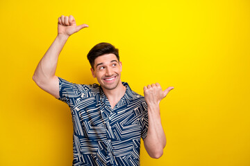 Poster - Portrait of positive nice person look indicate thumb fingers empty space ad isolated on yellow color background