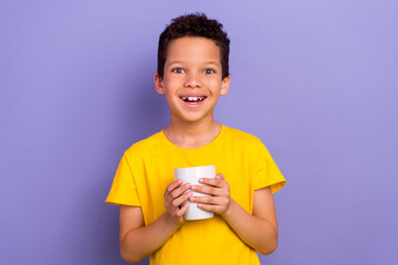 Poster - Photo of cheerful adorable boy wear trendy clothes drinking delicious beverage morning breakfast isolated on purple color background