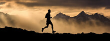 Trail Runner Nature Landscape Running Man Silhouette On Mountains Background In Cold Weather With Clouds At Sunset. Amazing Scenic View Of Peaks In Altitude.