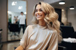 Beautiful smiling woman in hairdresser's chair in beauty salon