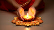 Embrace the rich tradition of lighting Diwali oil lamps as hands kindle the festival's warm and vibrant light.