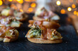 Christmas canapes made of pears, blue cheese and parma ham