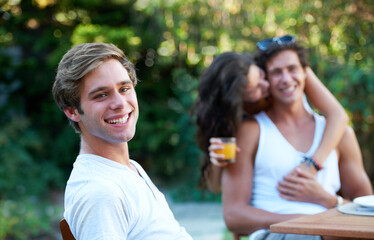 Wall Mural - Man, portrait and friends in a backyard at home with bbq and happy event by a table. Group, teenager and young people together in a summer in a garden with a smile and food for lunch outdoor