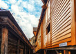 © atosan - Hanseatic commercial wooden buildings on each side of passageway Bryggen Bergen Norway UNESCO world Heritage Site