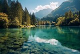 Fototapeta Natura - Scenic view of a lake with mountains reflecting in the clear water under a blue summer sky surrounded by a lush green forest in autumn. Generative AI