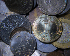 Wall Mural - Ukraini hryvnia coin on a pile of world coins