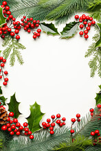 Christmas Frame With Holly Berries And Leaves,fir Tree Branches On White Background, Closeup, Top View