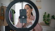 © stockbusters - Blogger woman filming makeup tutorial at house closeup. Talking girl review