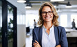 © Danny - businesswoman wearing glasses smiling standing in office