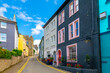 Historic buildings painted vibrant colors line the streets of the Irish seaside village of Kinsale, a historic port and fishing town in County Cork, Ireland.