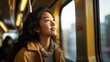 © Krtola  - Portrait of a young woman on public transportation looking out the window