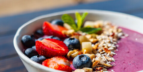 Poster - trendy delicious sweet fruit smoothie acai bowl with berries seeds nuts and granola on a caf 