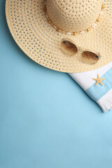 Canvas Print - Flat lay composition with beach accessories on light blue background, space for text