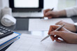 © rogerphoto - Two accountants use a calculator and tablet computer for counting taxes or revenue balance. Business, audit, and taxes concepts