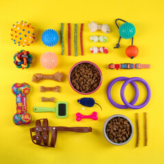 Wall Mural - Flat lay composition with different pet goods on yellow background. Shop assortment