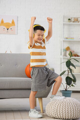 Poster - Little Asian boy in headphones dancing at home