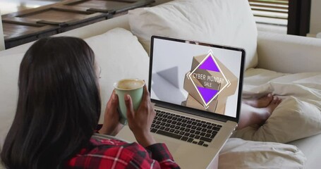 Sticker - Biracial woman using laptop at home online shopping on cyber monday sale day, slow motion