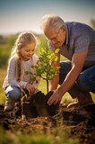 Fototapeta Lawenda - Héritage familial : Grand-père et petite-fille plantent un arbre ensemble