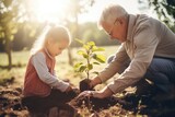 Fototapeta  - Héritage familial : Grand-père et petite-fille plantent un arbre ensemble
