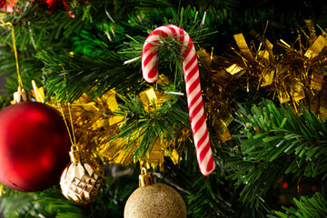 Wall Mural - Close up of christmas tree with candy cane, baubles, decorations and copy space