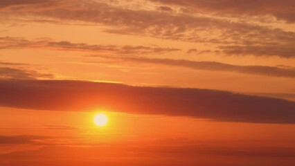 Wall Mural - The orange glow of the sunset transforms the landscape into a breathtaking view.