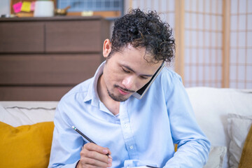 Wall Mural - Busy male professional businessman entrepreneur person sitting talking communication phone with working desk laptop notebook technology communication indoor home workplace, adult business man manager