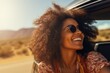 A black woman rides in a car and enjoys the views of the desert. Auto travel. Car trip.