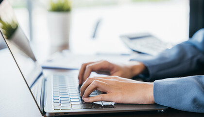 Close up of young woman hands typing on laptop computer keyboard making notes writing on device at cafe coffee shop desk, online, working female text message on computer, business and technology