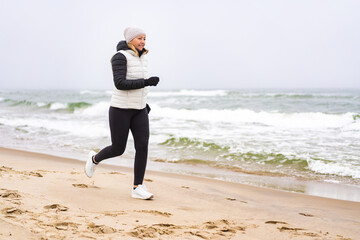 Wall Mural - Beautiful woman running on beach