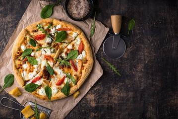 Wall Mural - Italian pizza with feta cheese, tomato and basil