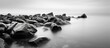 © The 2R Artificiality - Long exposure photograph of a rocky seascape scene at Odessa Ukraine featuring black sea and white tones With copyspace for text