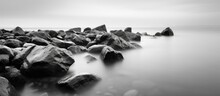 Long Exposure Photograph Of A Rocky Seascape Scene At Odessa Ukraine Featuring Black Sea And White Tones With Copyspace For Text