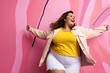 Happy plus size woman standing in front of a colorful wall. Body positivity, self confidence and self acceptance concept.