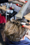 Fototapeta  - Suszenie włosów u fryzjera. Salon fryzjerski.